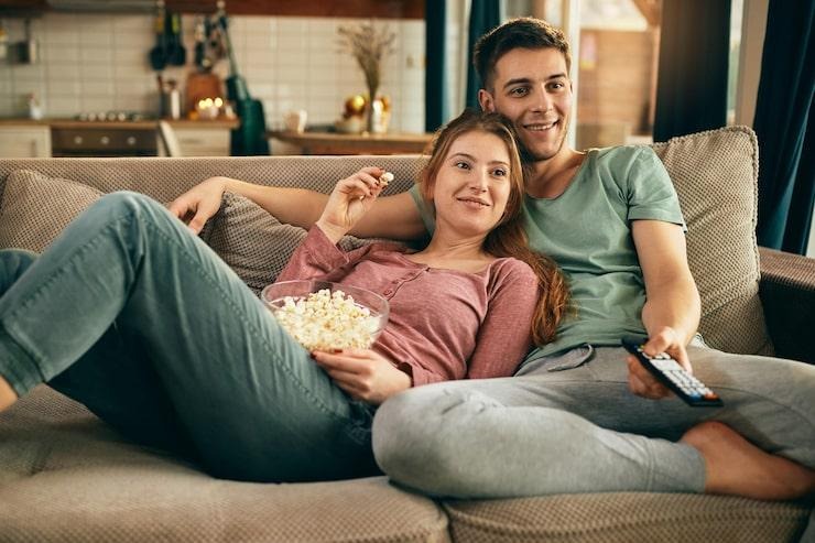 https://img.freepik.com/free-photo/smiling-couple-eating-popcorn-watching-tv-while-relaxing-sofa_637285-12673.jpg?semt=ais_rp_progressive&w=740&q=80
